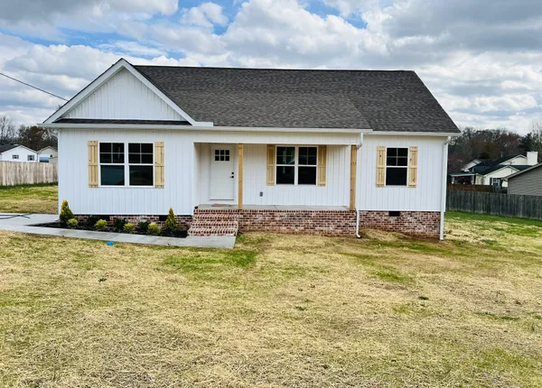 a front view of a house with a yard