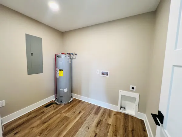 a view of a room with wooden floor and cabinet