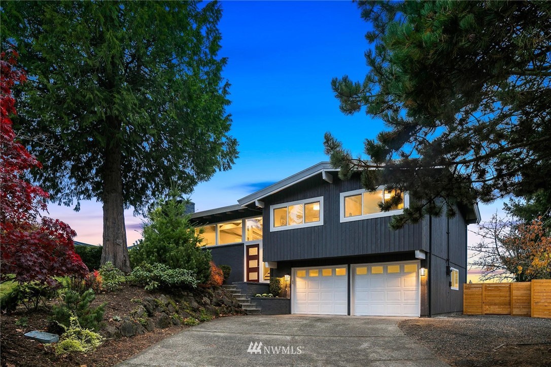 12110 Southeast 60th Place Bellevue, WA 98006 - Photo 2 of 32 a front view of a house with a yard and garage