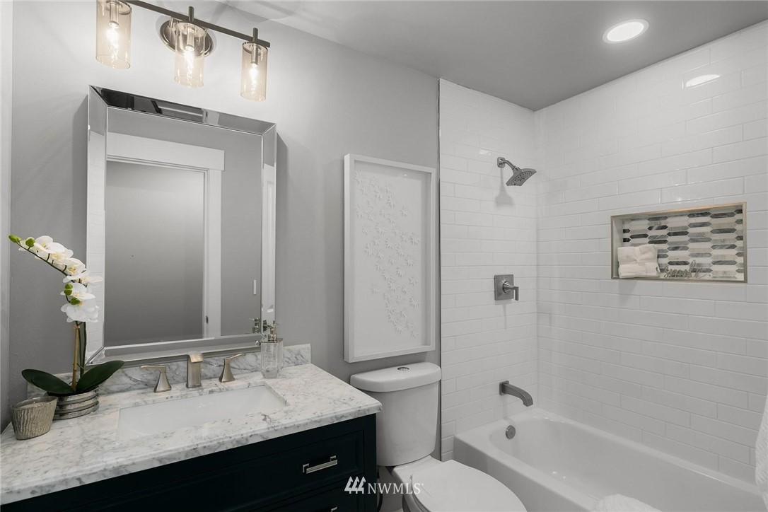 12110 Southeast 60th Place Bellevue, WA 98006 - Photo 18 of 32 a bathroom with a granite countertop sink toilet and shower
