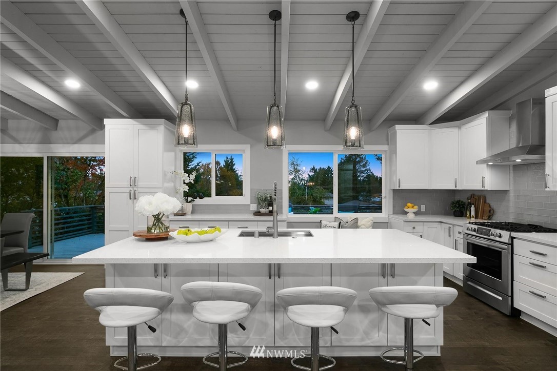 12110 Southeast 60th Place Bellevue, WA 98006 - Photo 9 of 32 a kitchen with a dining table chairs and white cabinets