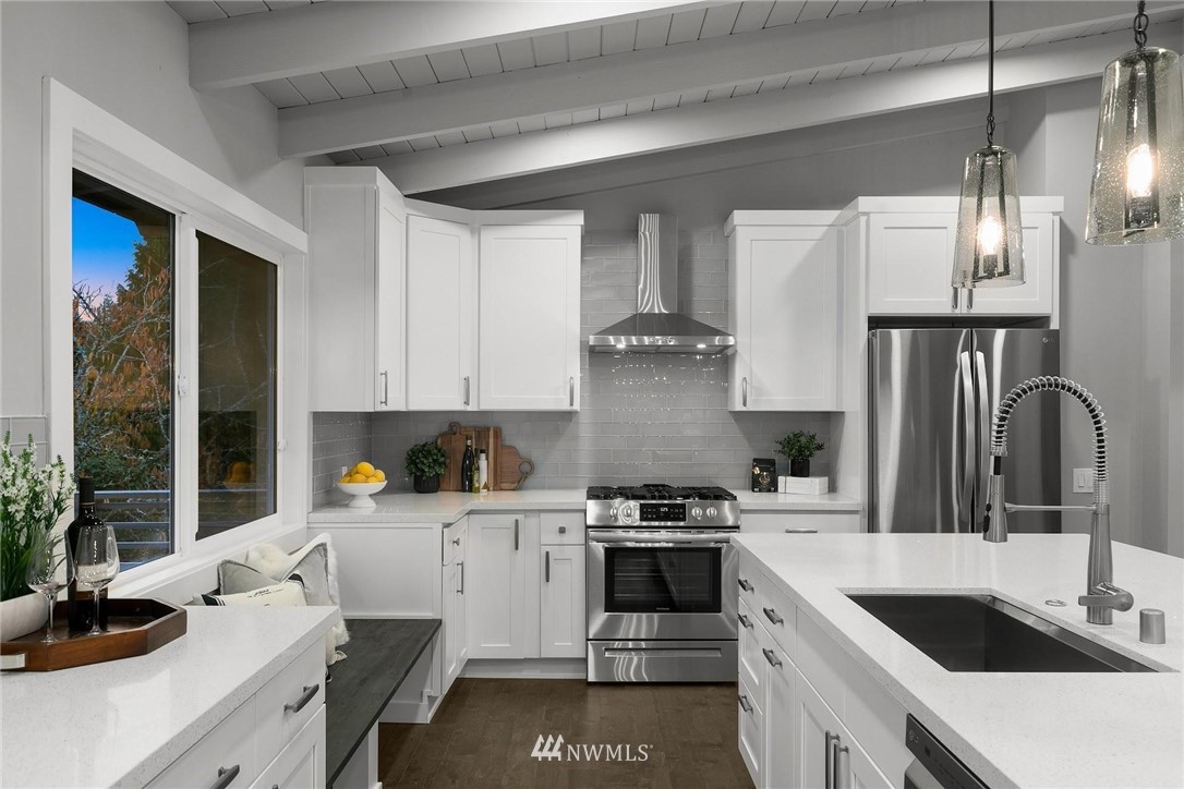 12110 Southeast 60th Place Bellevue, WA 98006 - Photo 10 of 32 a kitchen with a sink stove top oven and cabinets