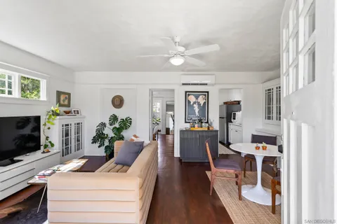 a living room with furniture potted plant and a window