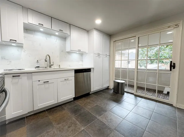 a kitchen with a sink a stove a refrigerator and cabinets