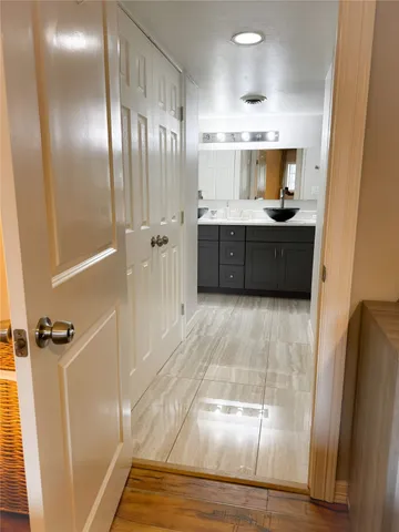 a bathroom with a double vanity sink a mirror and a shower