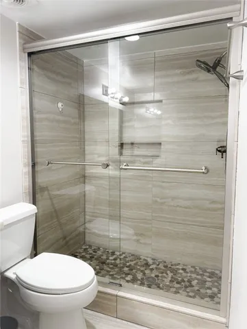 a bathroom with a shower and a toilet