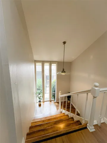 a view of entryway and hall with wooden floor