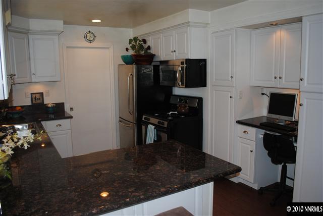 355 Andria Drive Stateline, NV 89449 - Photo 1 of 13 a kitchen with stainless steel appliances granite countertop a sink stove and refrigerator