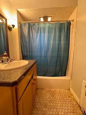 a kitchen with refrigerator and cabinets