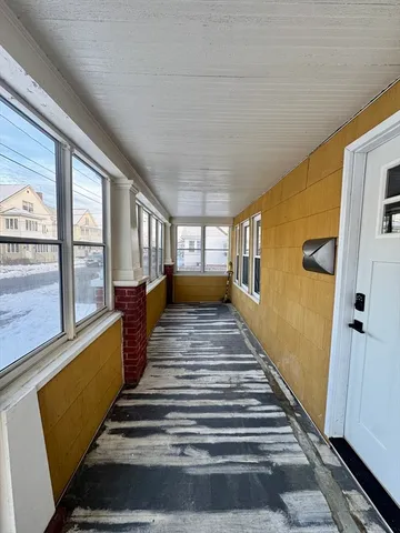 a view of a room with wooden floor and windows