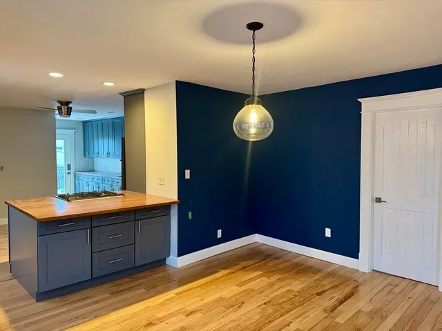a view of a room with a sink and wooden floor