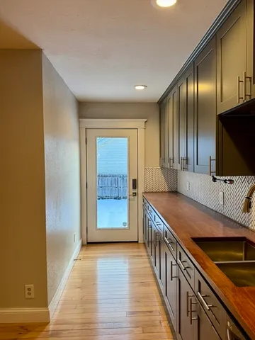 a kitchen with stainless steel appliances granite countertop a sink and a refrigerator