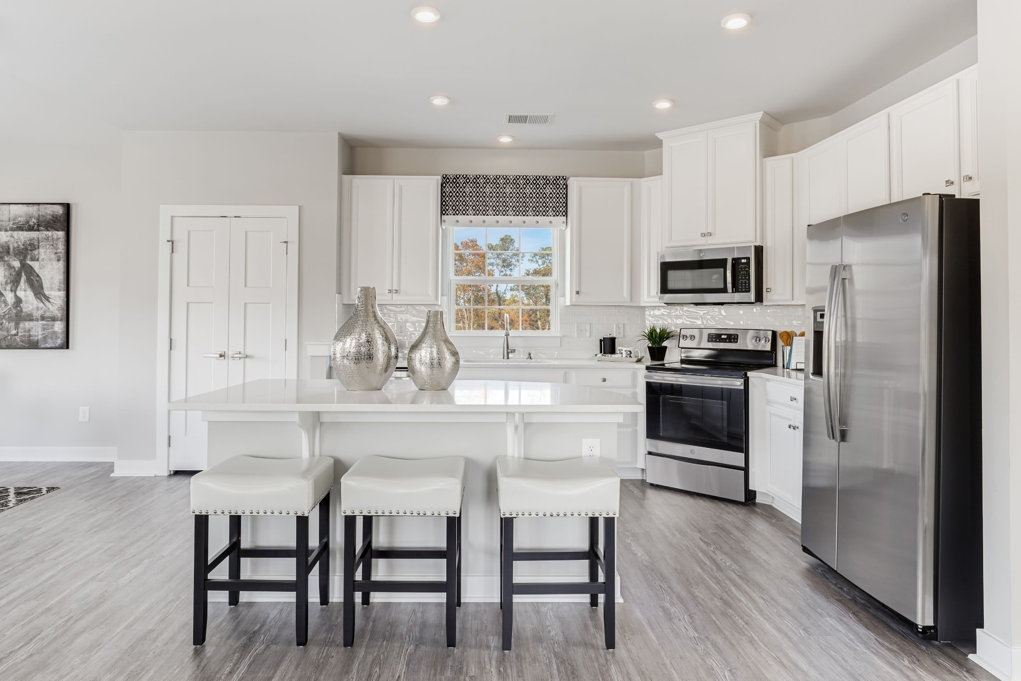 4019 Oglethorpe Drive Franklin, TN 37064 - Photo 10 of 31 a kitchen with kitchen island white cabinets and stainless steel appliances