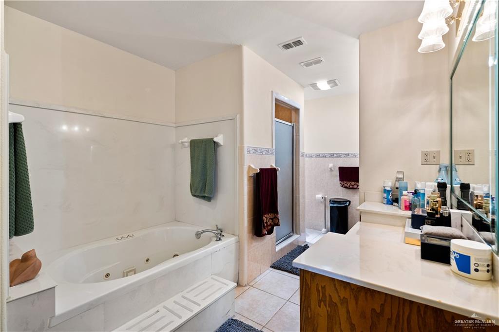 501 South Greene Road Mission, TX 78572 - Photo 14 of 28 a bathroom with a tub sink and a mirror
