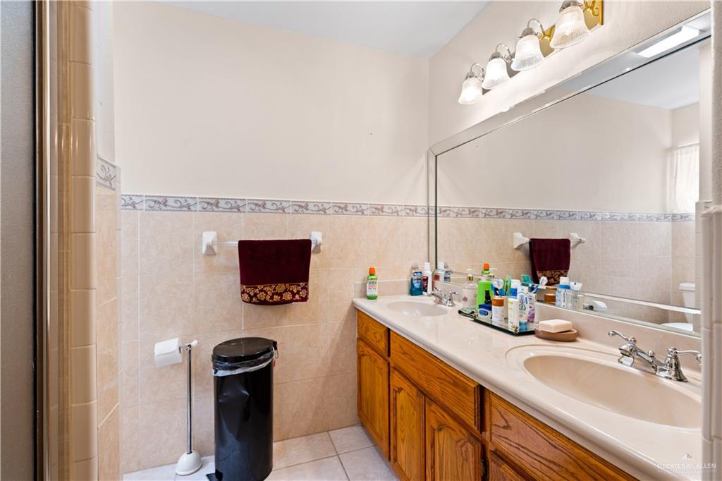 501 South Greene Road Mission, TX 78572 - Photo 15 of 28 a bathroom with a sink and a mirror