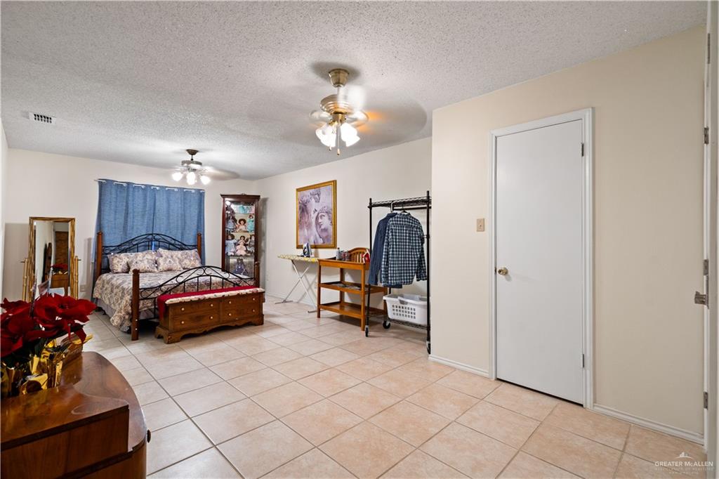 501 South Greene Road Mission, TX 78572 - Photo 18 of 28 a bedroom with furniture and a bed