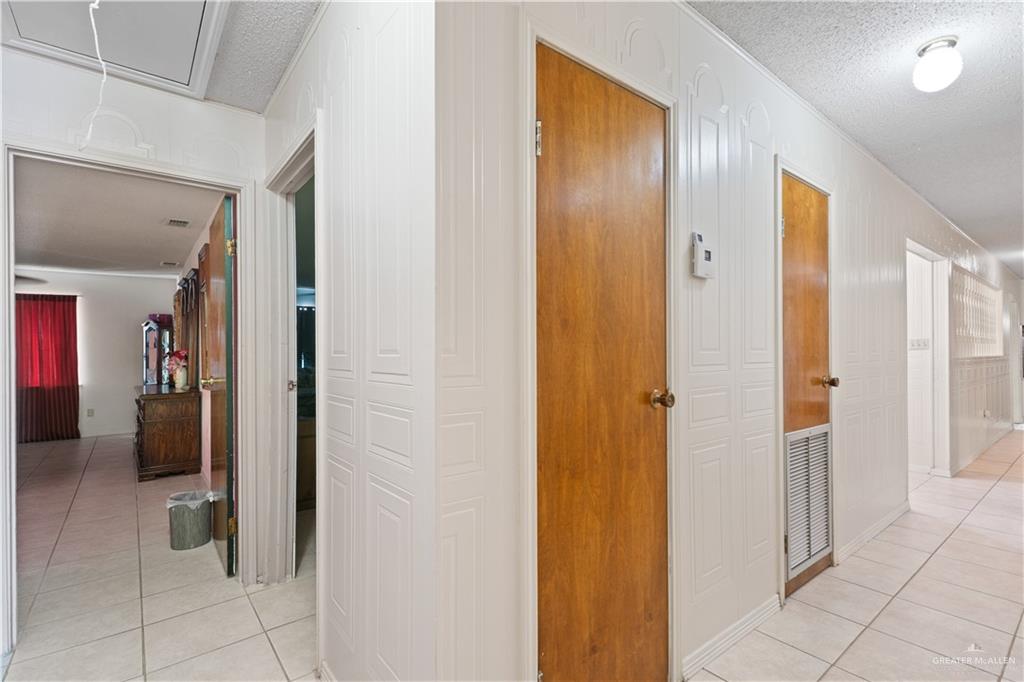 501 South Greene Road Mission, TX 78572 - Photo 19 of 28 a view of a hallway with closet and a bathroom