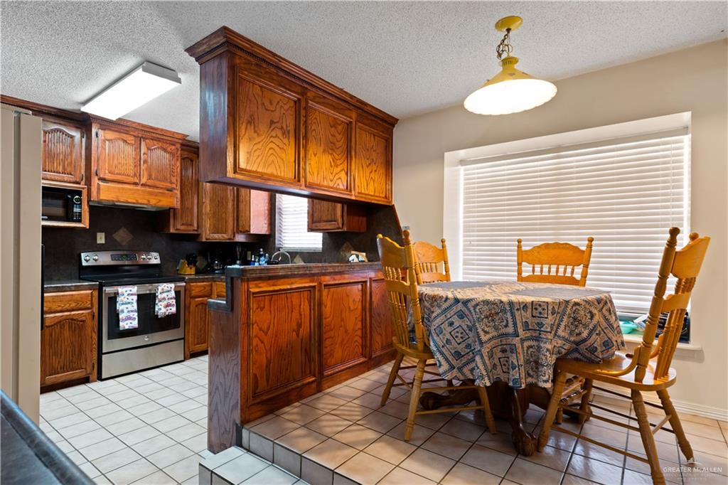 501 South Greene Road Mission, TX 78572 - Photo 8 of 28 a view of living room kitchen with stainless steel appliances granite countertop furniture and a table