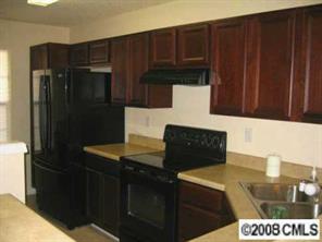 16868 Timber Crossing Road Charlotte, NC 28213 - Photo 2 of 8 a kitchen with granite countertop a refrigerator and a stove top oven
