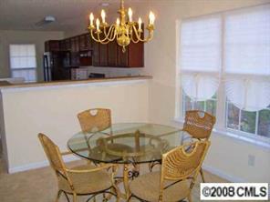16868 Timber Crossing Road Charlotte, NC 28213 - Photo 3 of 8 a view of a dining room with furniture and chandelier