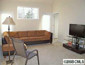 16868 Timber Crossing Road Charlotte, NC 28213 - Photo 4 of 8 a living room with a couch and a flat screen tv
