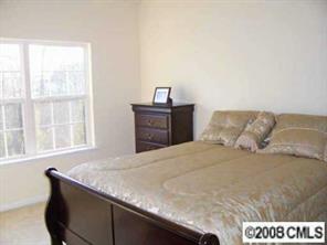 16868 Timber Crossing Road Charlotte, NC 28213 - Photo 5 of 8 a bedroom with a bed and a window