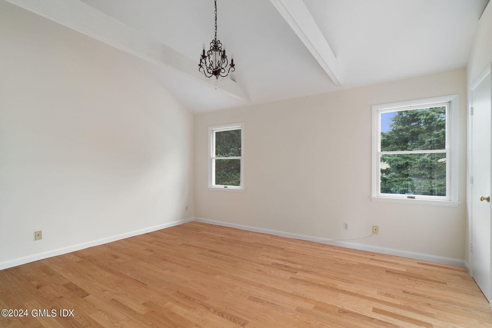 10 Tulip Street, Unit A Cos Cob, CT 06807 - Photo 12 of 27 a view of an empty room with wooden floor and a window