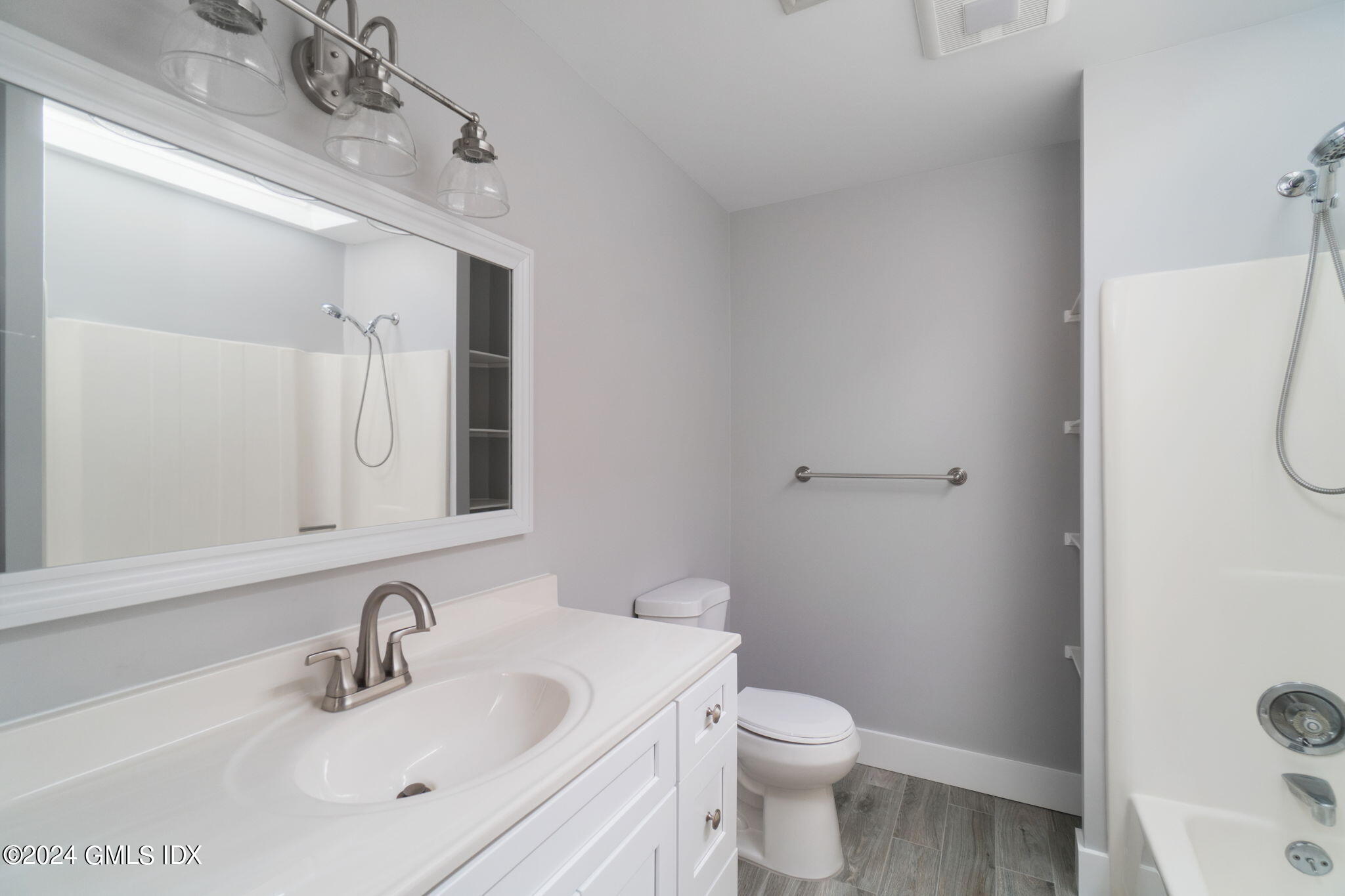 10 Tulip Street, Unit A Cos Cob, CT 06807 - Photo 16 of 27 a bathroom with a sink toilet and shower