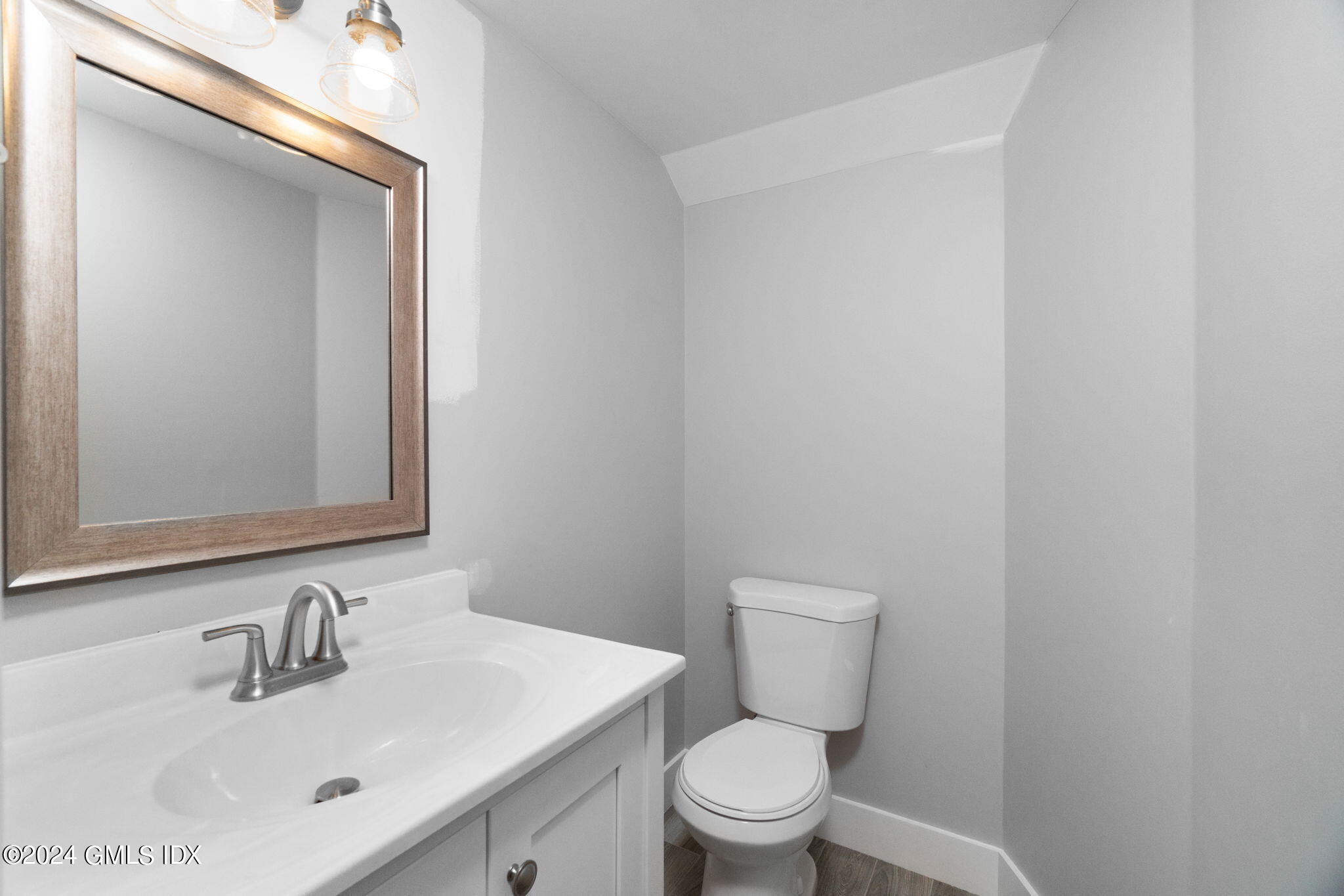 10 Tulip Street, Unit A Cos Cob, CT 06807 - Photo 17 of 27 a bathroom with a toilet a sink and mirror