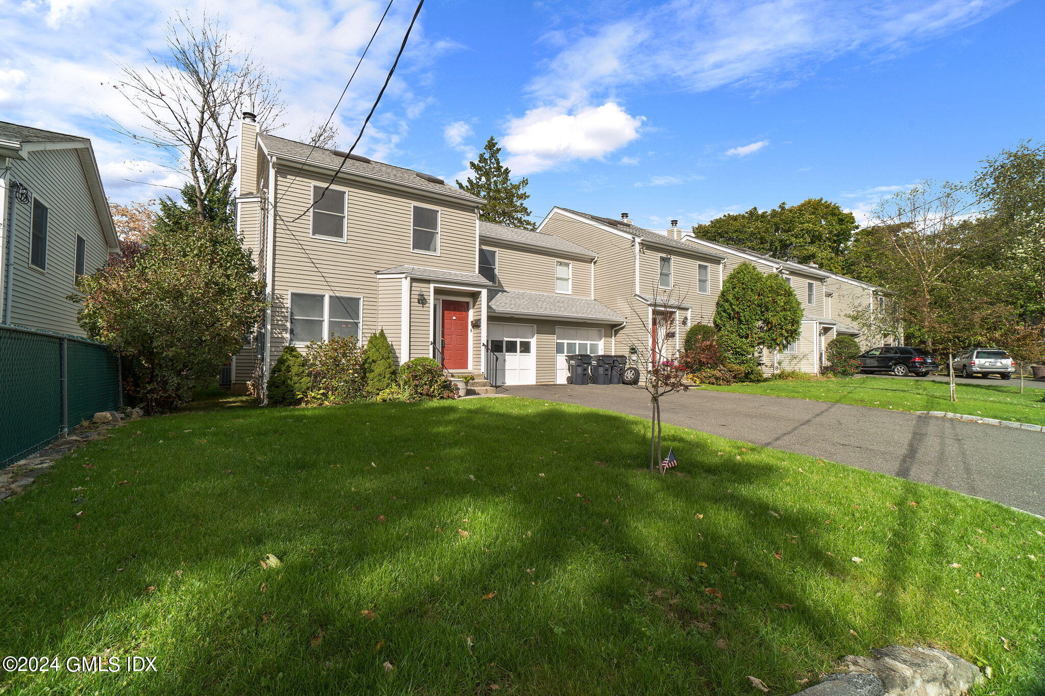10 Tulip Street, Unit A Cos Cob, CT 06807 - Photo 21 of 27 a view of a house with a big yard plants and large trees