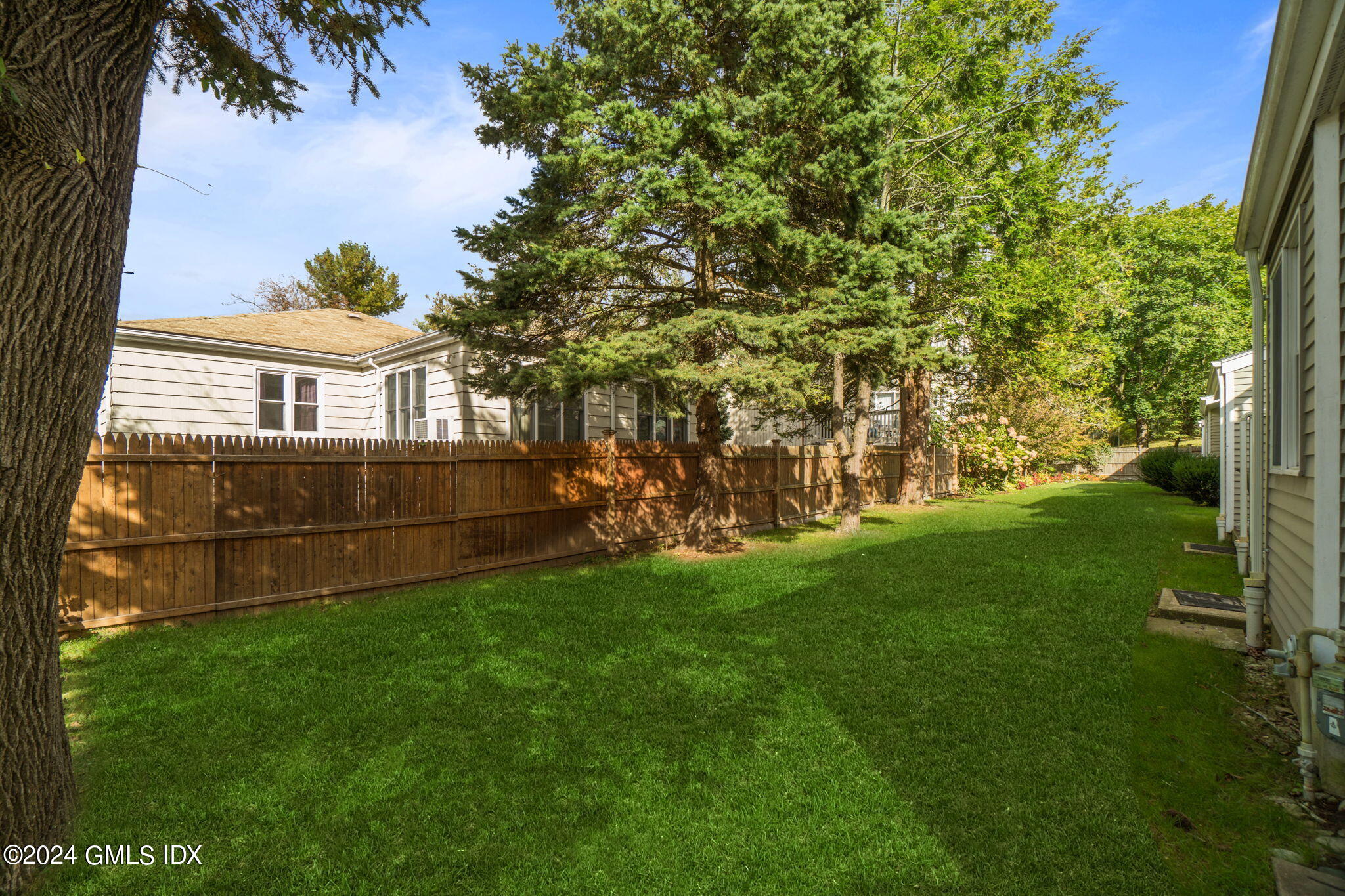 10 Tulip Street, Unit A Cos Cob, CT 06807 - Photo 25 of 27 a view of backyard with green space