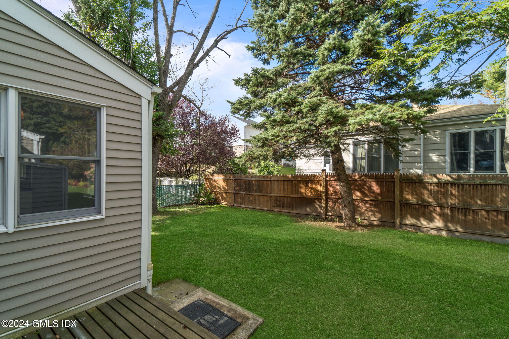 10 Tulip Street, Unit A Cos Cob, CT 06807 - Photo 26 of 27 a view of backyard with a garden and deck