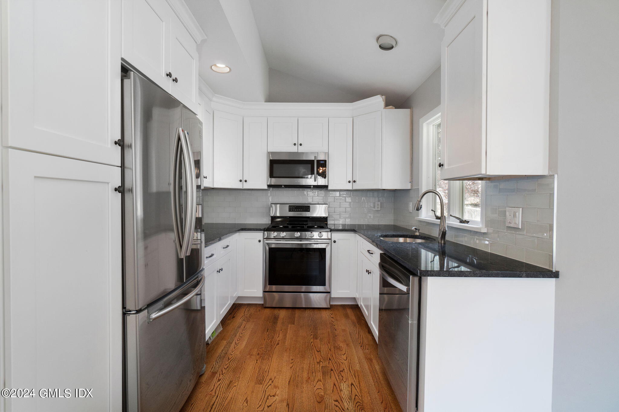 10 Tulip Street, Unit A Cos Cob, CT 06807 - Photo 3 of 27 a kitchen with a refrigerator a stove top oven and a sink