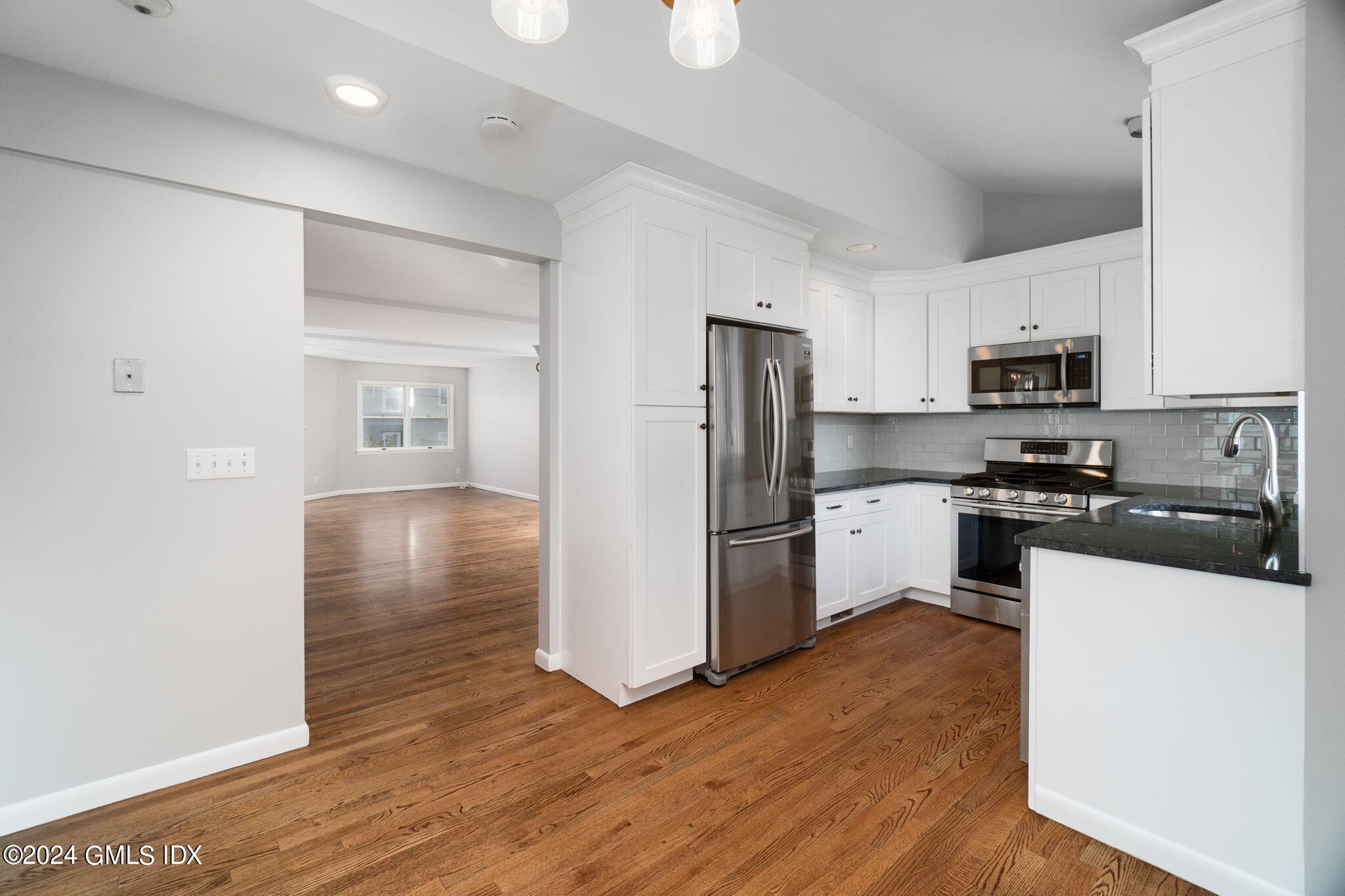10 Tulip Street, Unit A Cos Cob, CT 06807 - Photo 4 of 27 a kitchen with granite countertop a refrigerator and a stove top oven