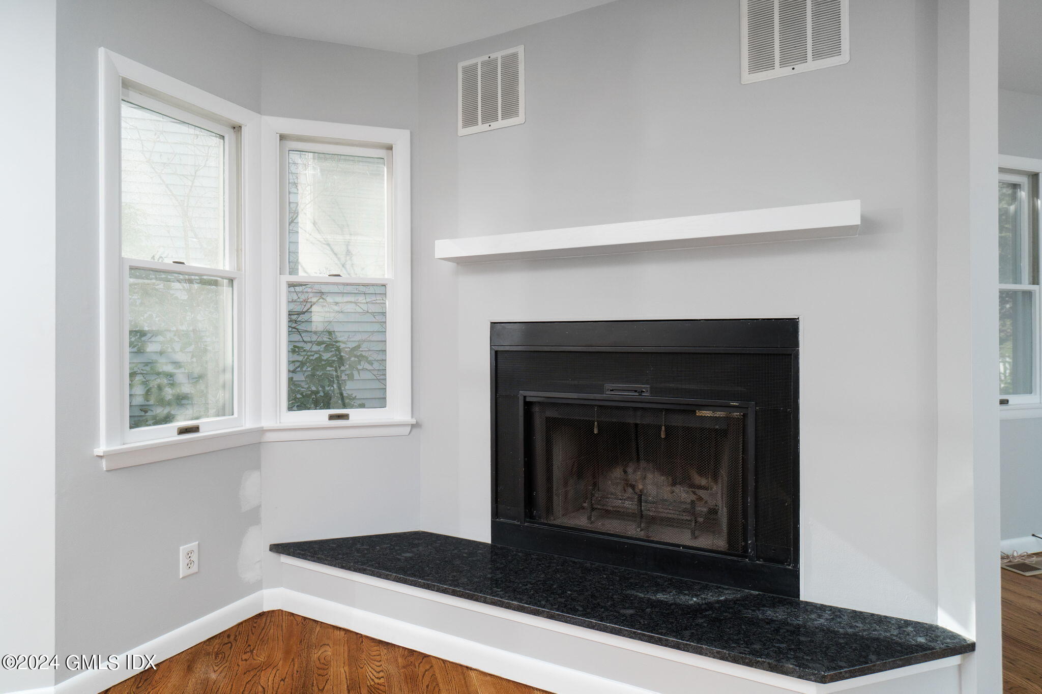 10 Tulip Street, Unit A Cos Cob, CT 06807 - Photo 6 of 27 a living room with a fireplace