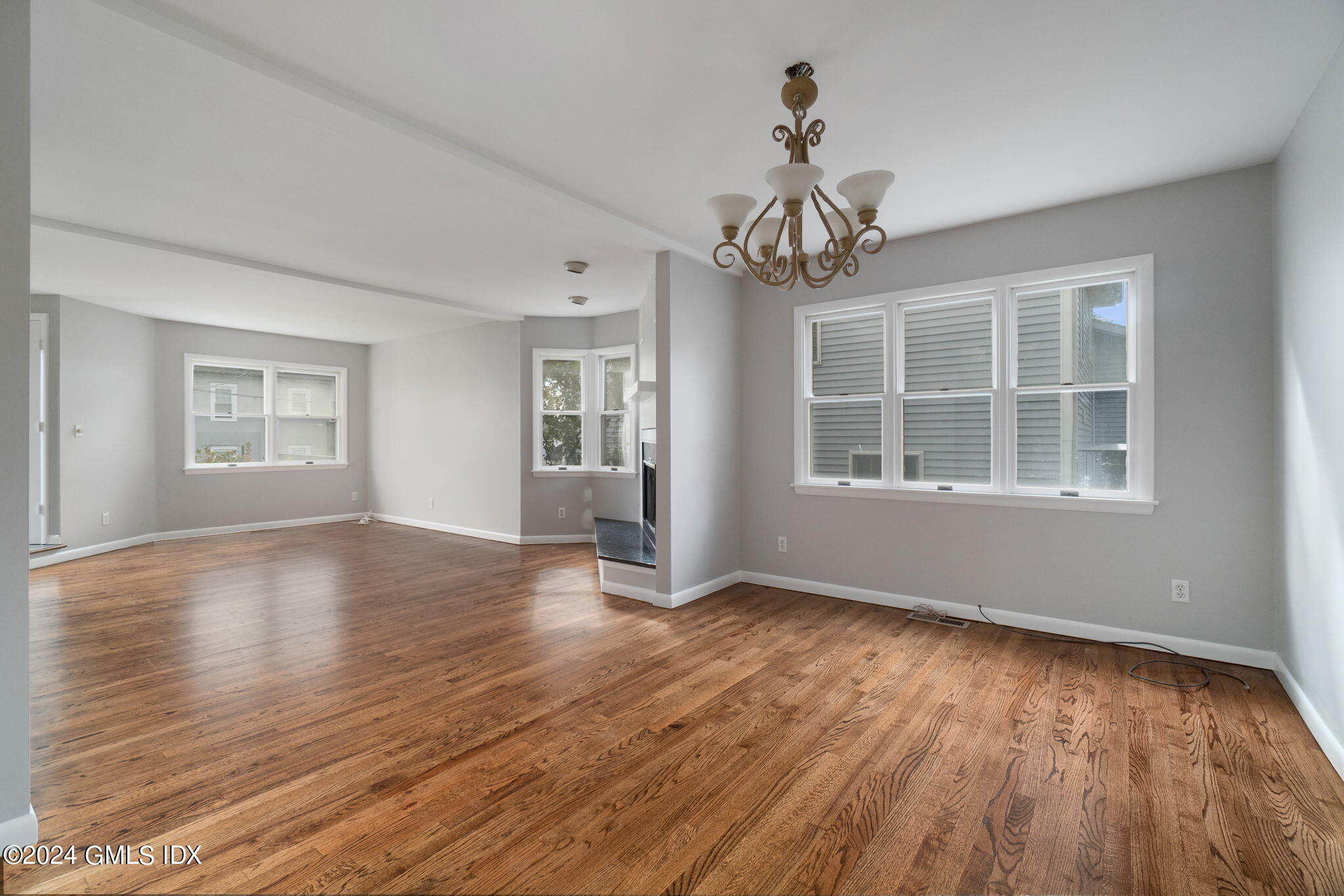 10 Tulip Street, Unit A Cos Cob, CT 06807 - Photo 9 of 27 a view of an empty room with wooden floor and a window