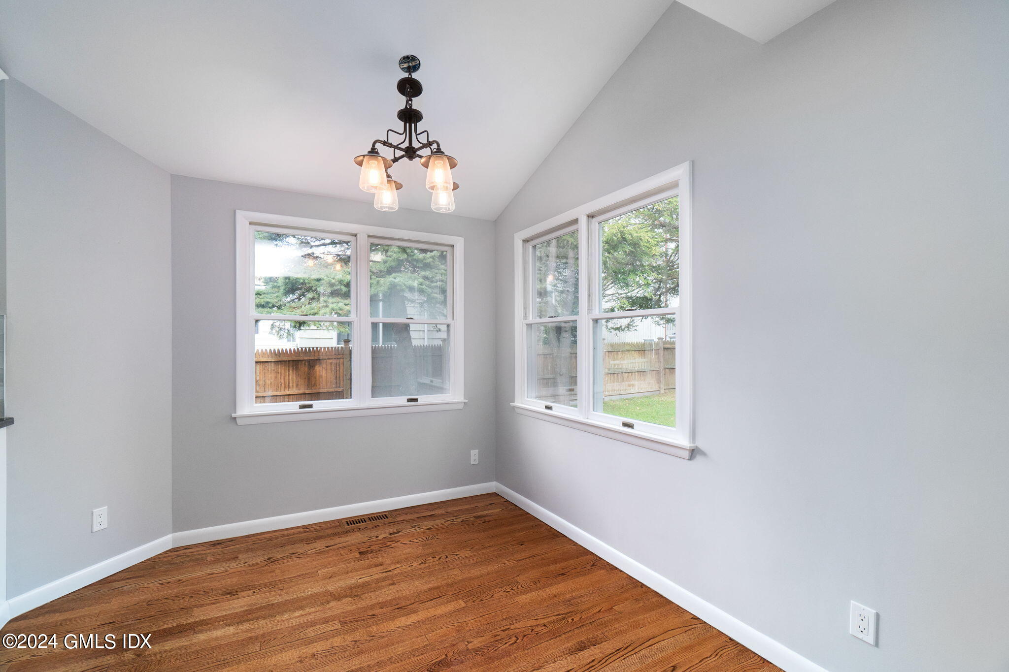 10 Tulip Street, Unit A Cos Cob, CT 06807 - Photo 10 of 27 an empty room with wooden floor and windows