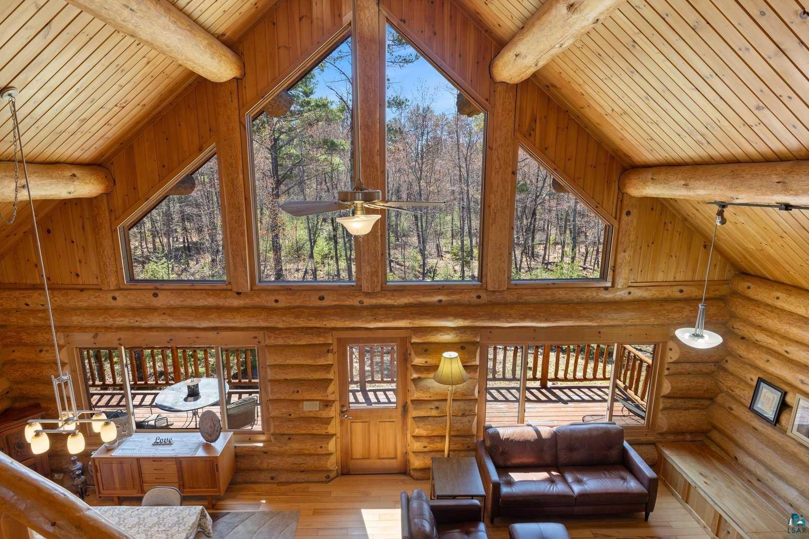 12957 West Ridge Road Ely, MN 55731 - Photo 11 of 41 Living room with plenty of natural light, wood ceiling, high vaulted ceiling, hardwood / wood-style flooring, and beam ceiling