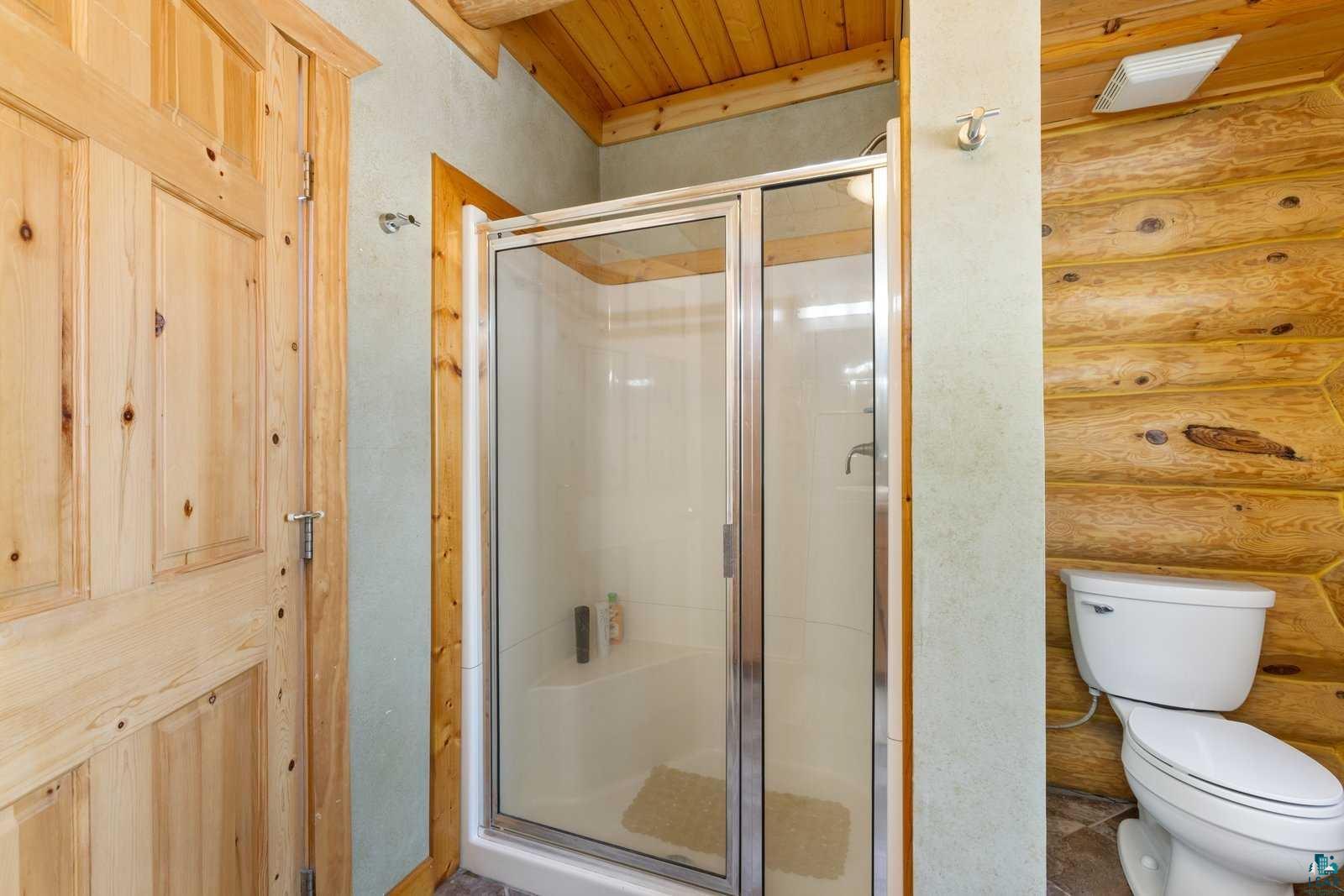 12957 West Ridge Road Ely, MN 55731 - Photo 13 of 41 Full bath with wooden ceiling, toilet, and a shower stall