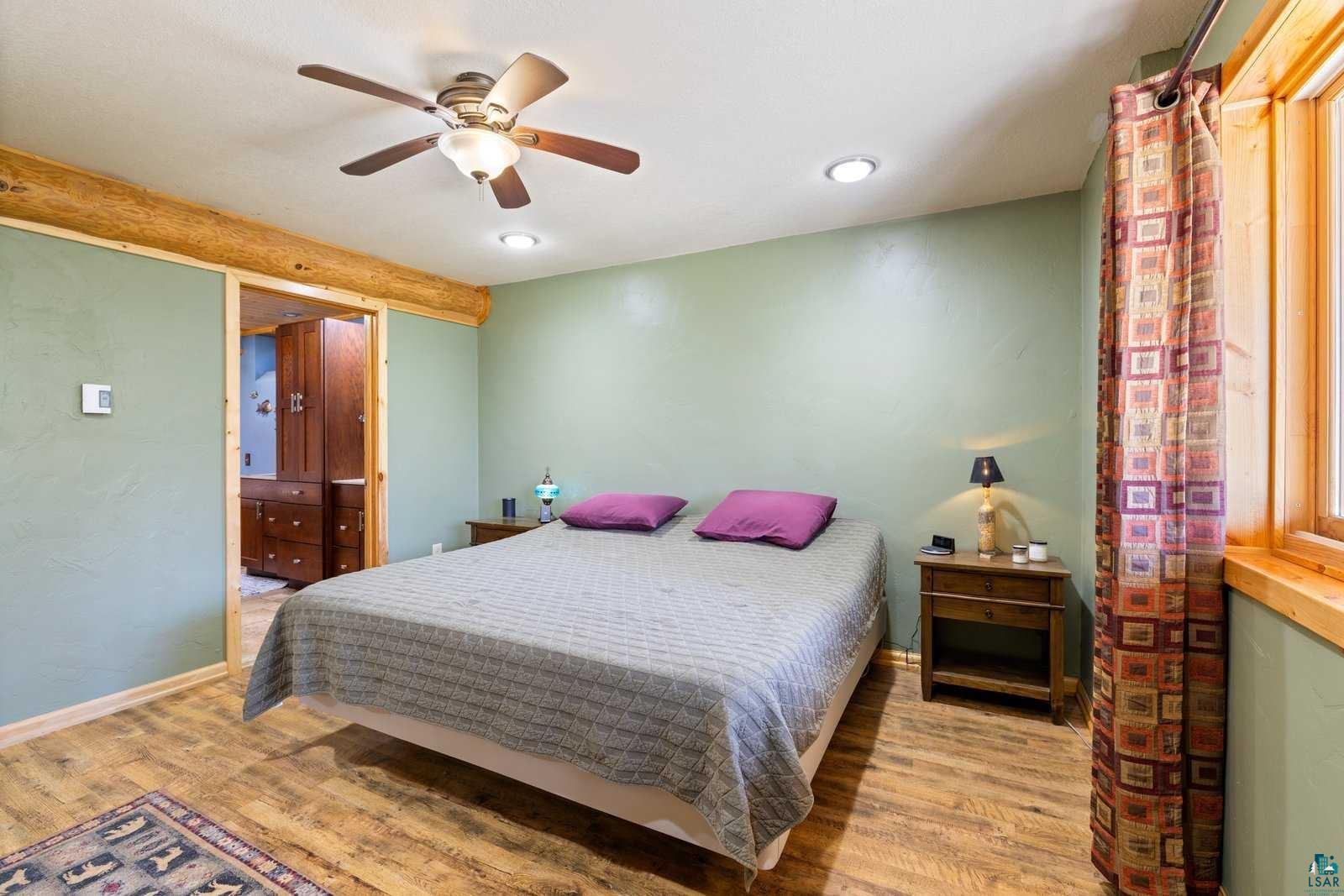 12957 West Ridge Road Ely, MN 55731 - Photo 21 of 41 Bedroom with baseboards, recessed lighting, a ceiling fan, and wood finished floors