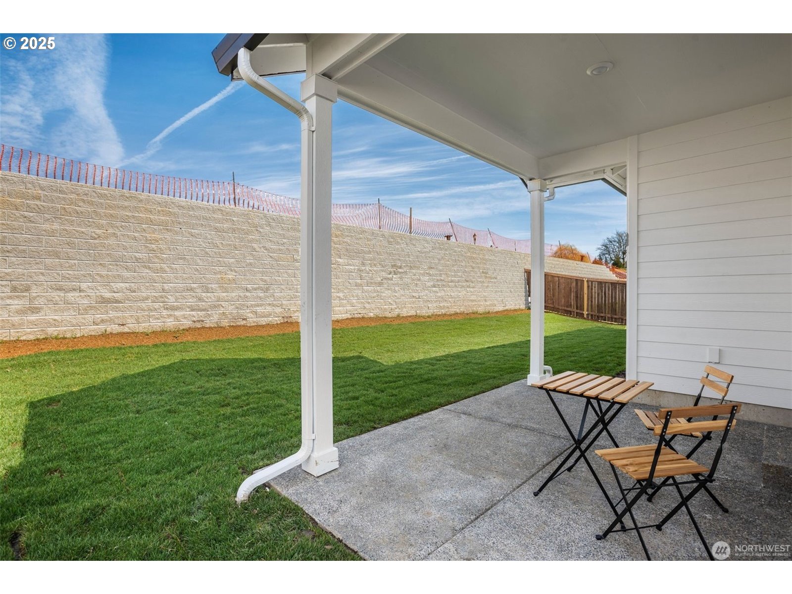 2822 South 9th Avenue Ridgefield, WA 98642 - Photo 19 of 27 a view of a backyard with table and chairs with wooden fence