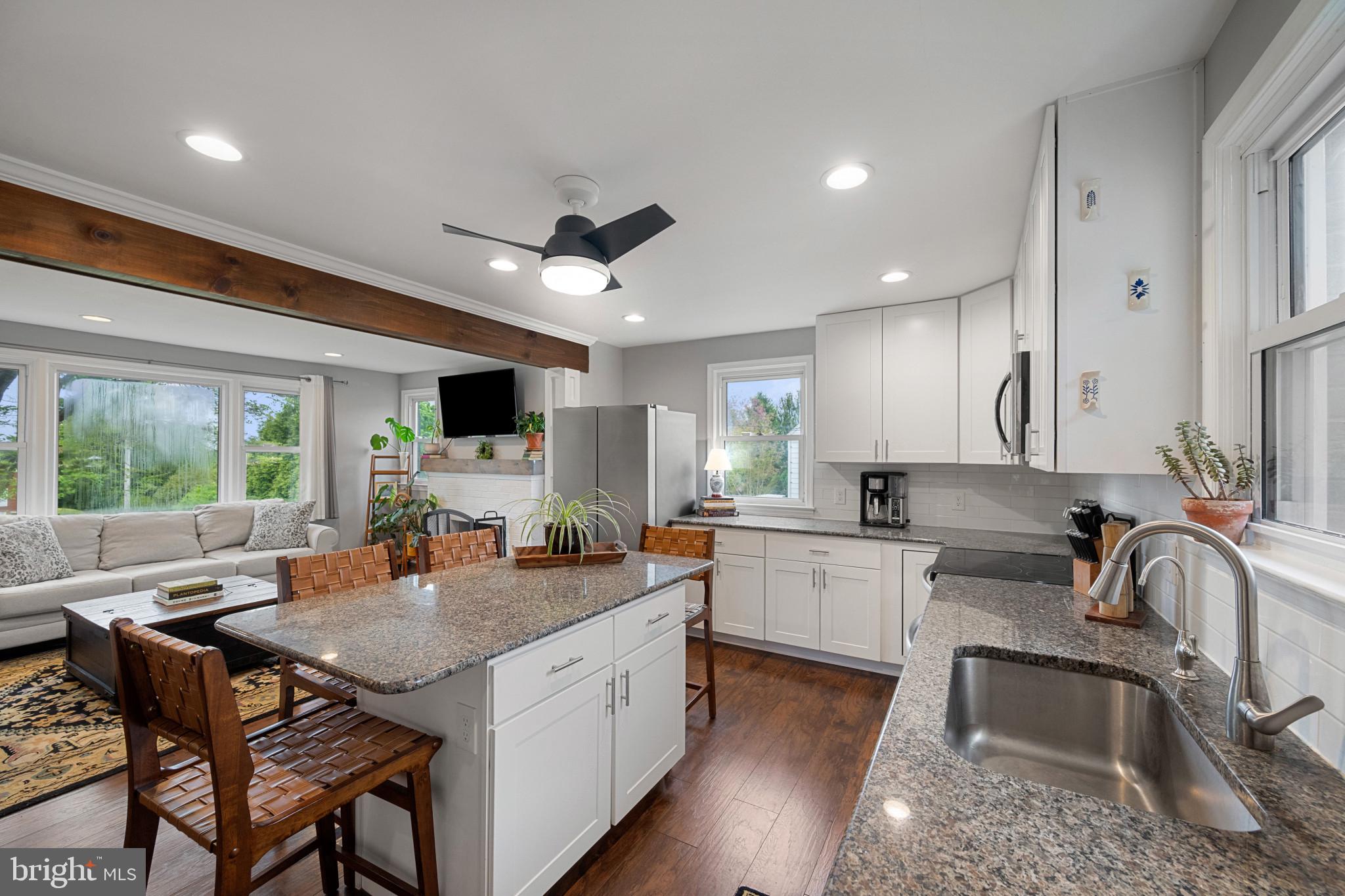 705 Longview Avenue Westminster, MD 21157 - Photo 11 of 30 a kitchen with a sink a counter top space and living room filled with furniture