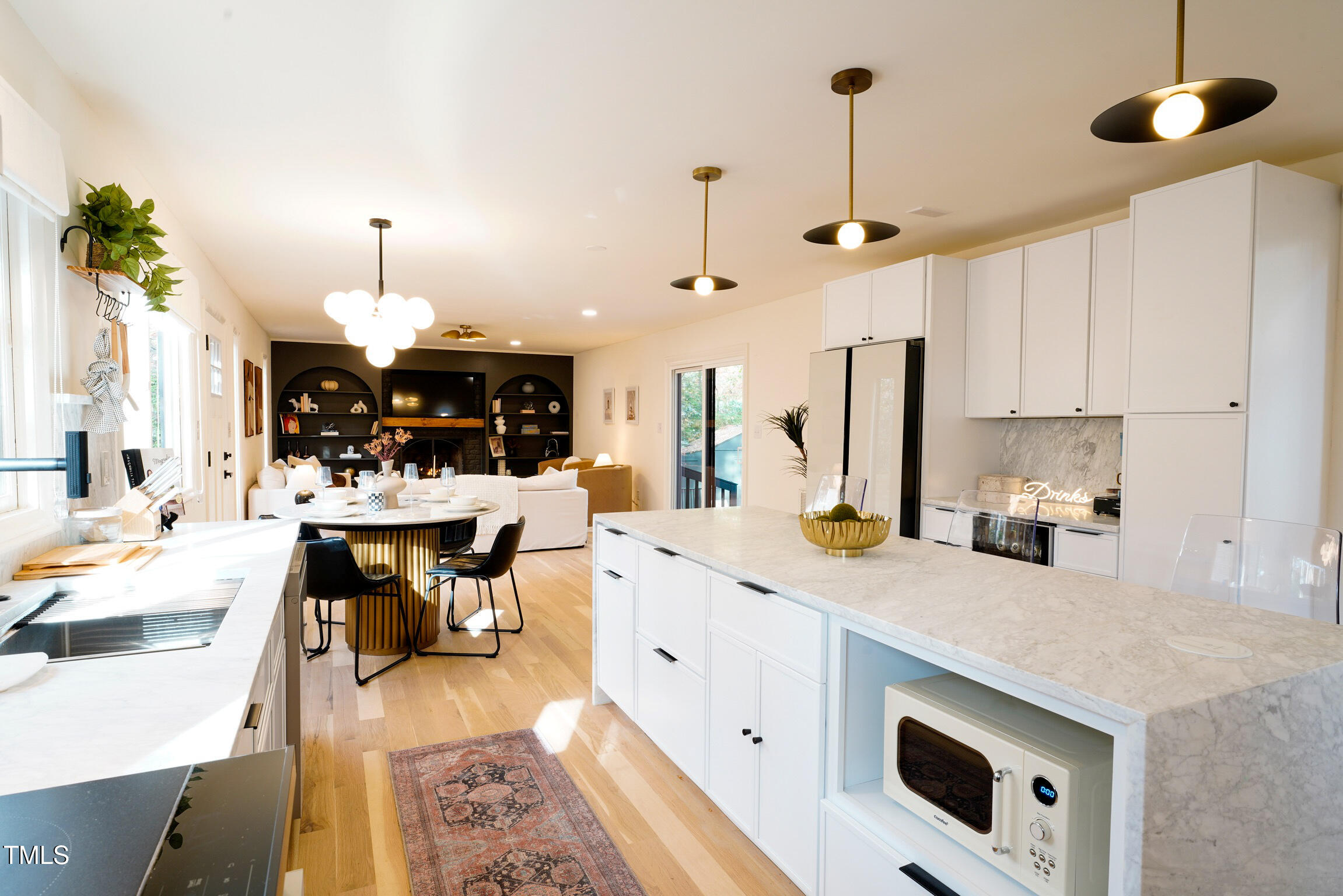 225 Woods Ream Drive Raleigh, NC 27615 - Photo 11 of 45 a kitchen with a sink stove and white cabinets