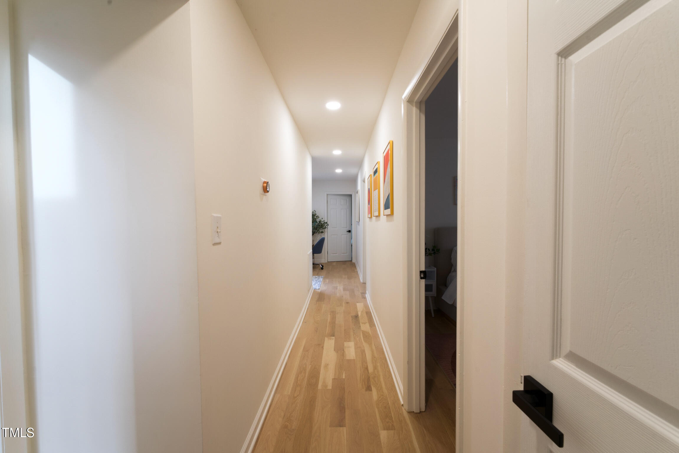 225 Woods Ream Drive Raleigh, NC 27615 - Photo 17 of 45 a view of a hallway with wooden floor