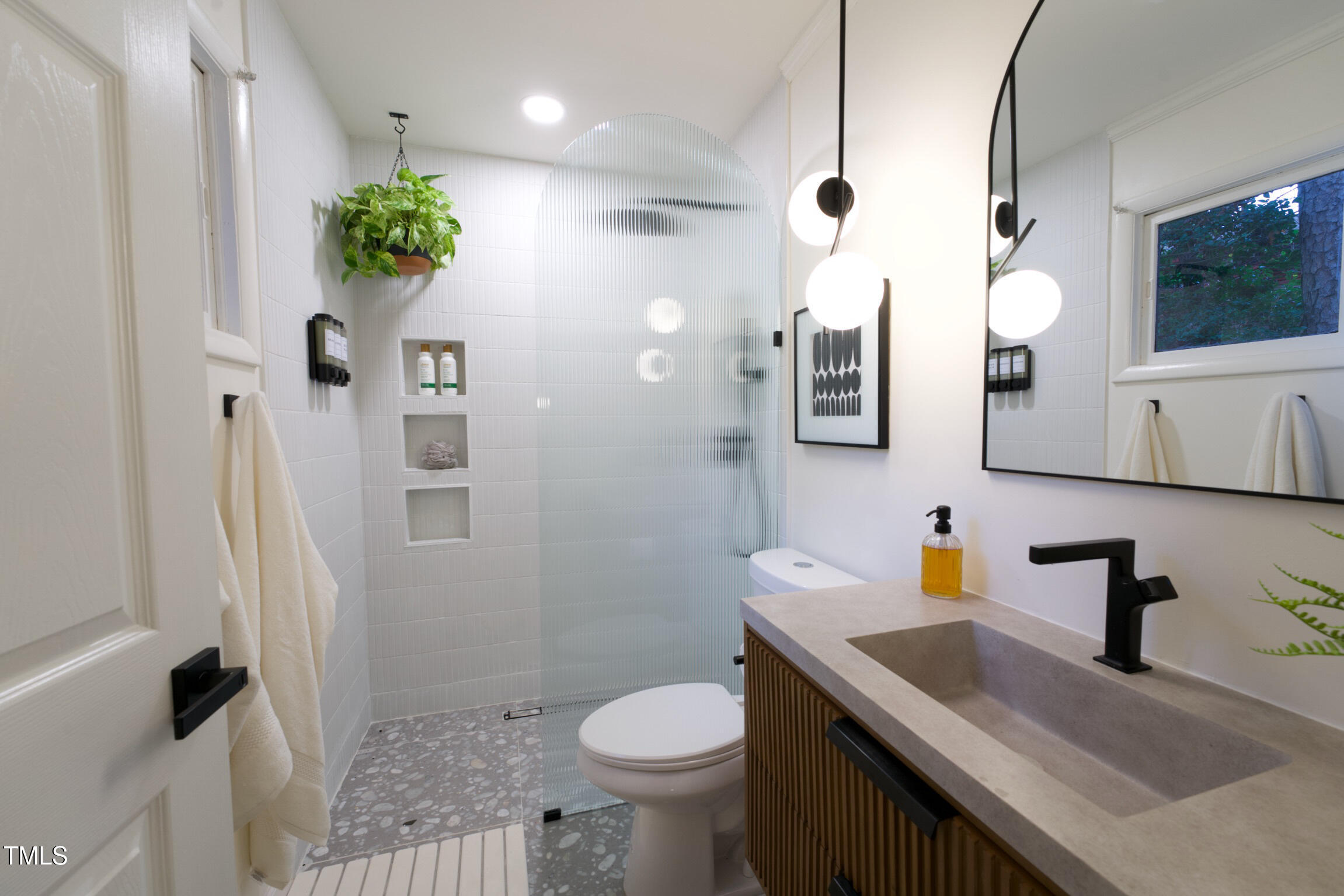 225 Woods Ream Drive Raleigh, NC 27615 - Photo 28 of 45 a bathroom with a sink toilet and shower