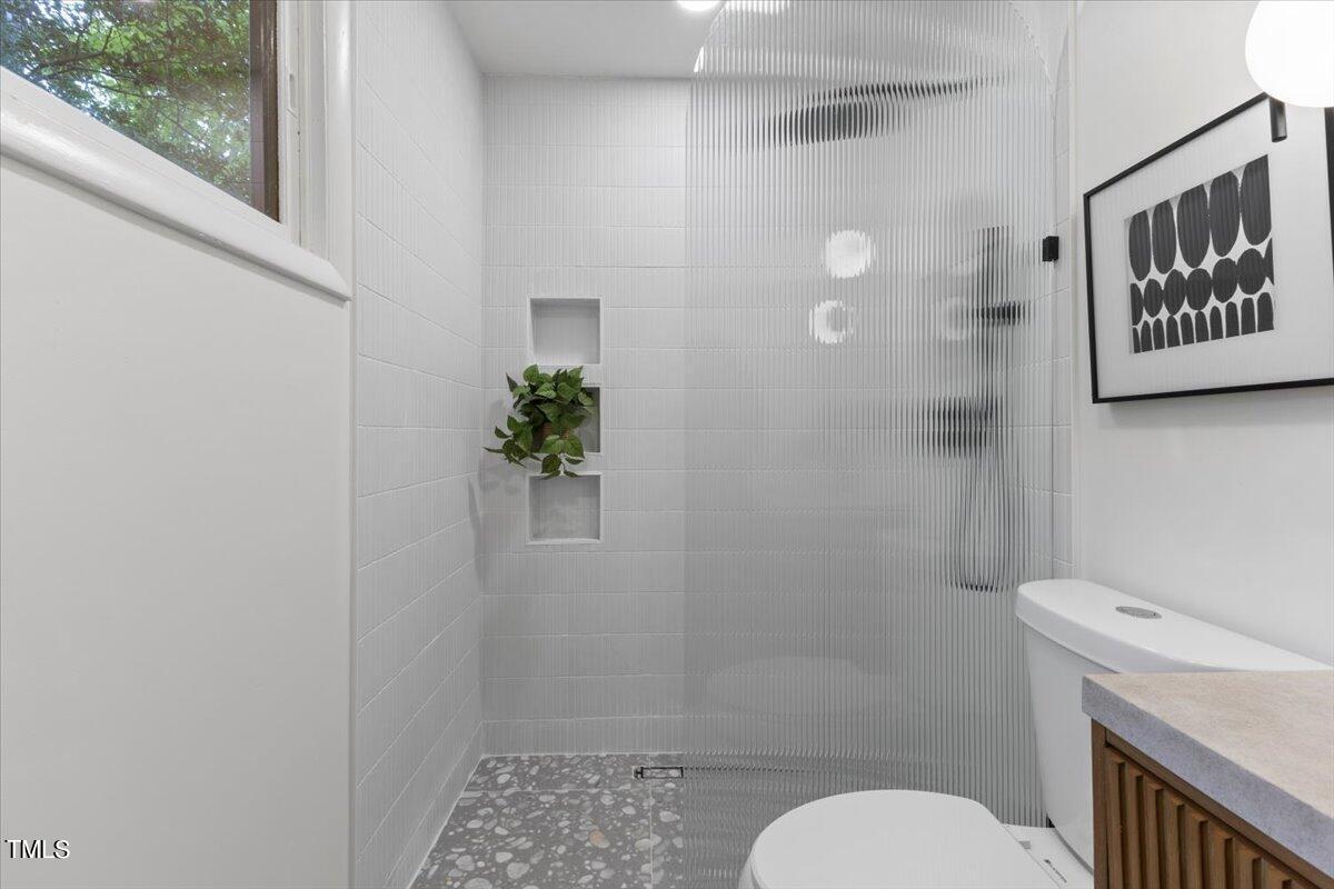 225 Woods Ream Drive Raleigh, NC 27615 - Photo 29 of 45 a bathroom with a toilet and a shower