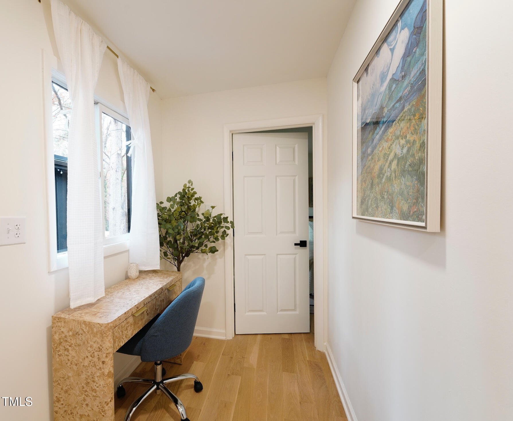225 Woods Ream Drive Raleigh, NC 27615 - Photo 31 of 45 a view of a workspace with furniture and a potted plant