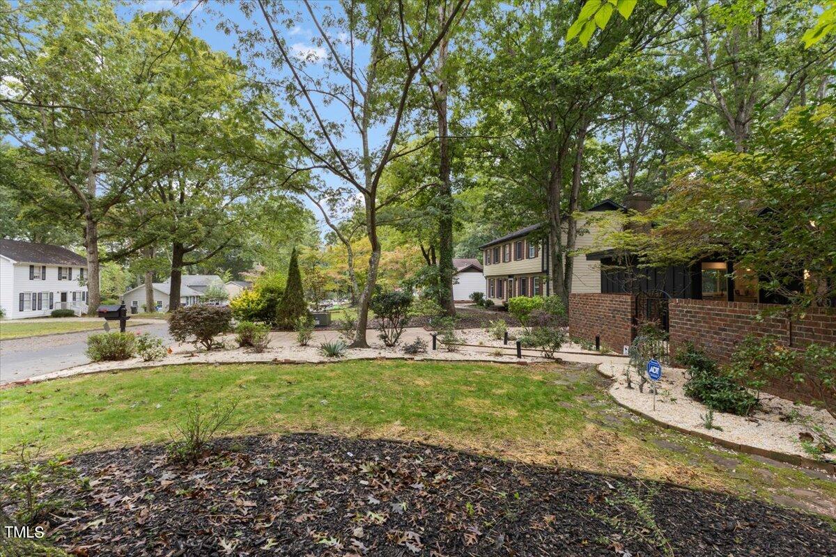 225 Woods Ream Drive Raleigh, NC 27615 - Photo 4 of 45 a view of a house with a yard and sitting area