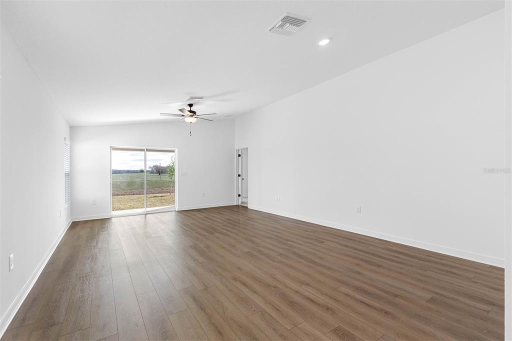 10405 Timbercrest Road Spring Hill, FL 34608 - Photo 7 of 14 wooden floor in an empty room with a window