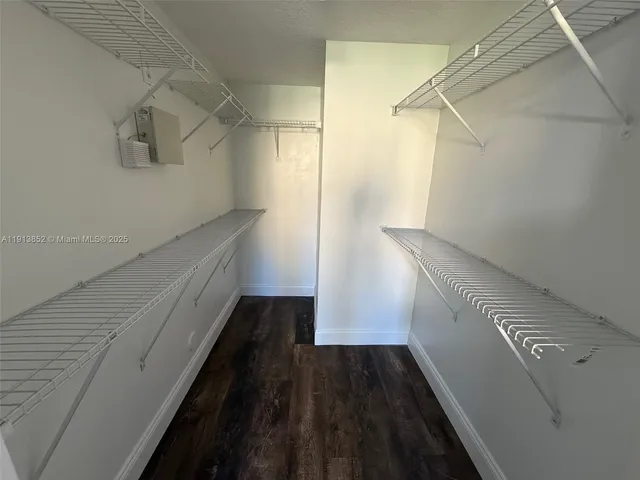 a view of hallway with wooden floor